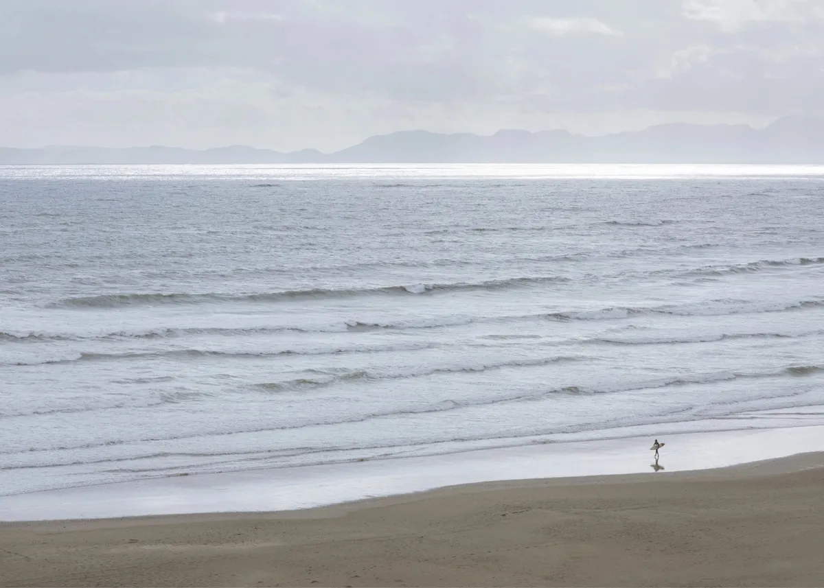 Waves rolling onto a grey beach